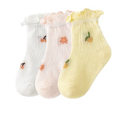 Three pairs of socks with colorful flower patterns, perfect for adding a touch of floral charm to your outfit.